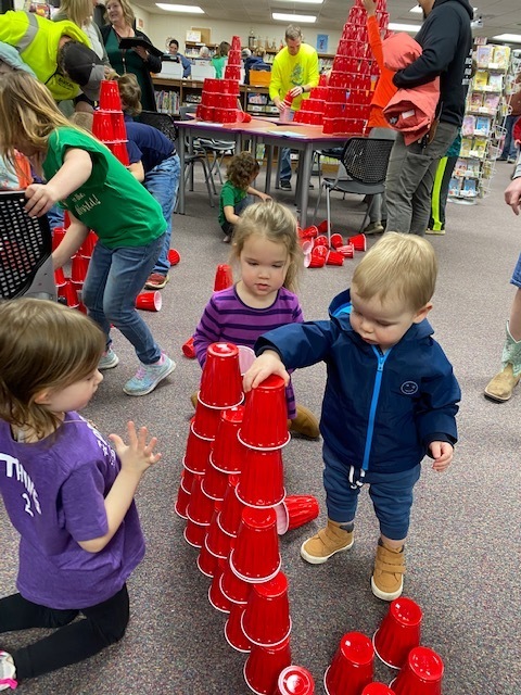 Children making cup towers