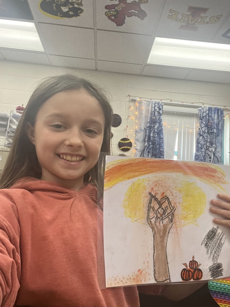 Student showing completed artwork